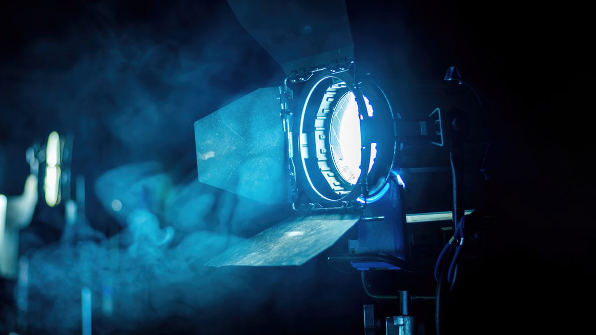 Focusing light through a high-tech projection system for film production.