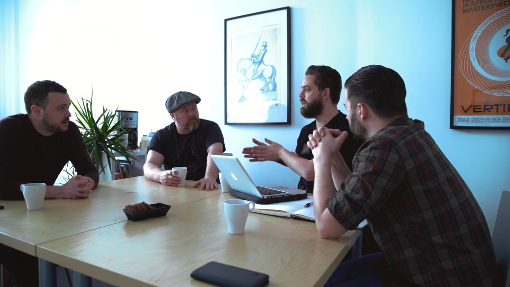 Thoughtful team discussion during a creative video production meeting at Film Division studio in London.