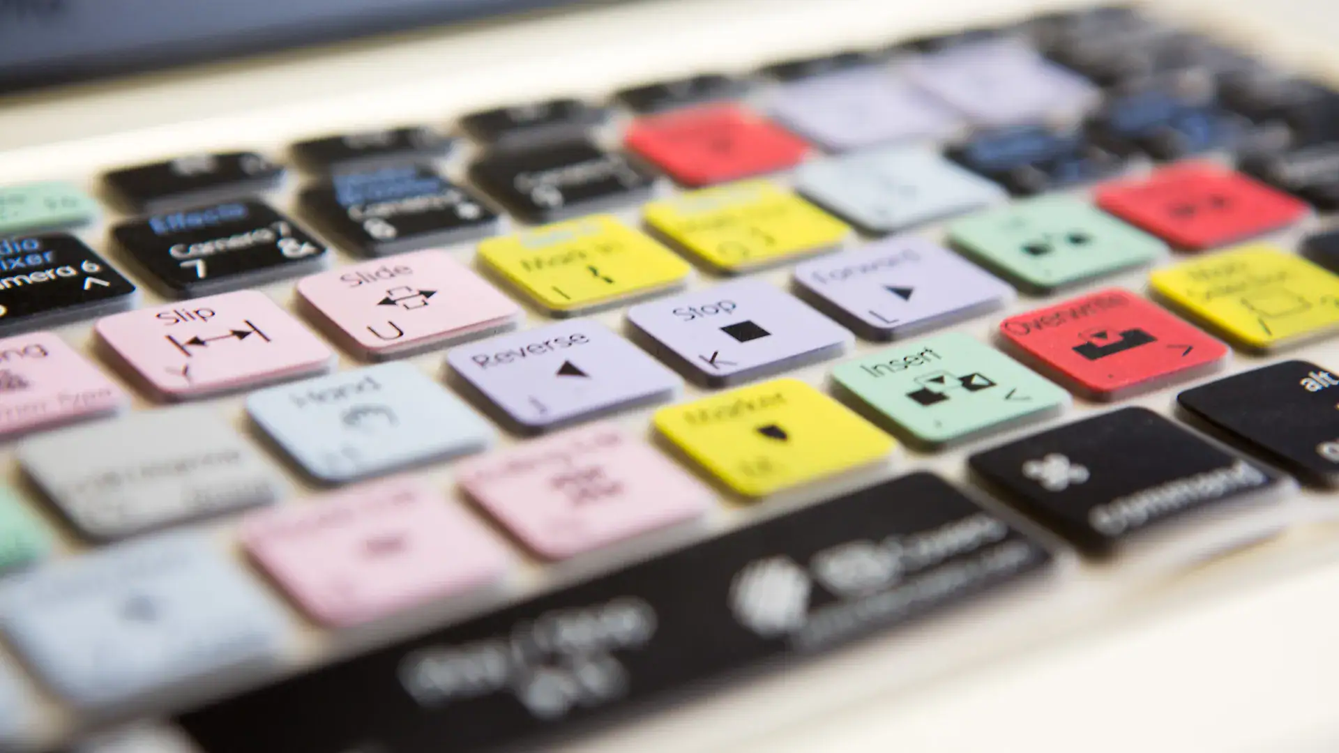 Keyboard with colourful multimedia and control keys used in video editing and filmmaking.