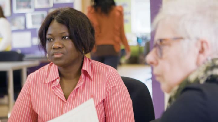 Diversity in filmmaking - professional women engaged in a discussion in a creative workspace.