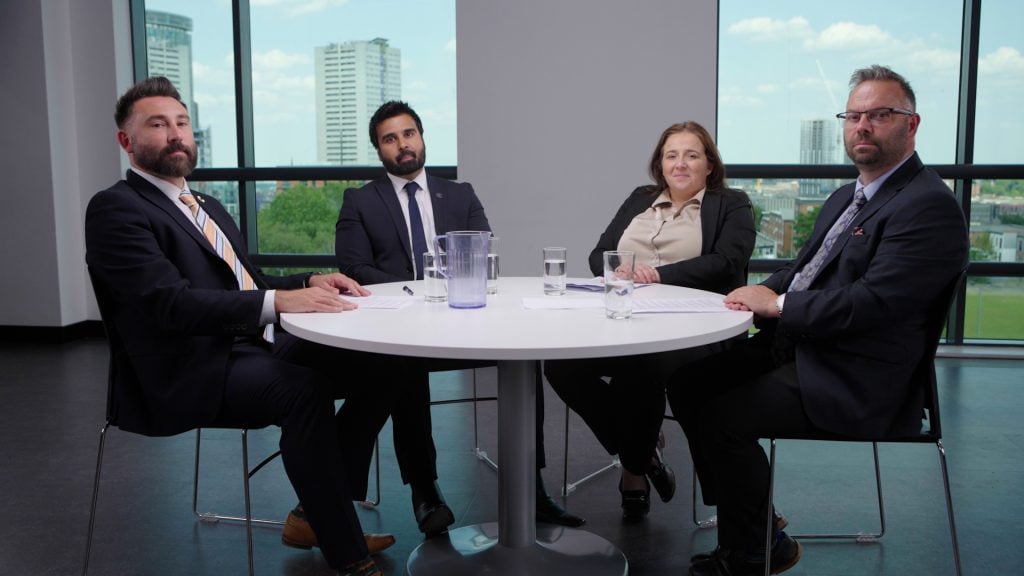 Professional business meeting with diverse team of four in modern office.
