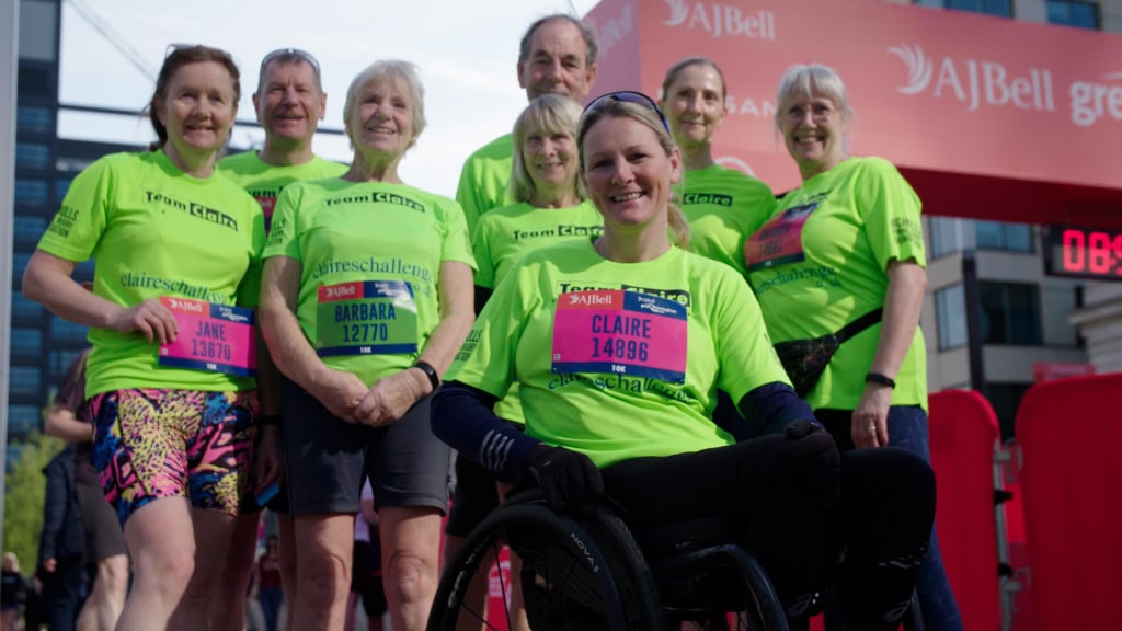 Vibrant group of elderly marathon runners in neon green shirts at the starting line. Authentic video content