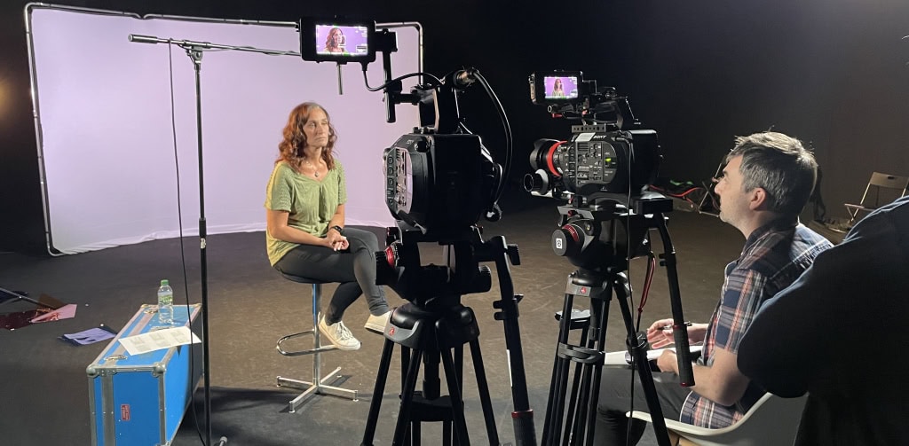 Filming a woman for a professional video production at Film Division, highlighting cinematic storytelling and video content creation.