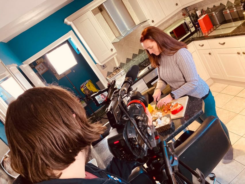 Preparing a food scene for filming in a kitchen setting for a cooking show or tutorial for video production.