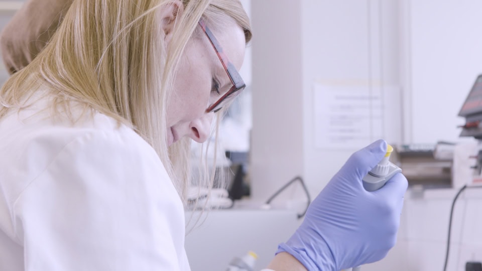 PCR test being conducted by a healthcare professional in a laboratory.