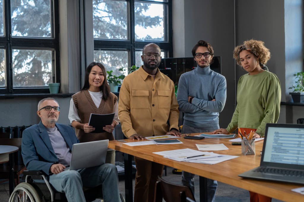 Diverse team of professionals collaborating in modern office for film and media production.