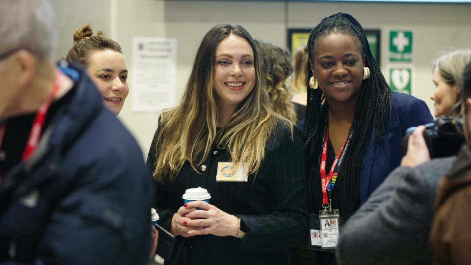 Women engaged in discussion at an event, showcasing networking and professional collaboration.