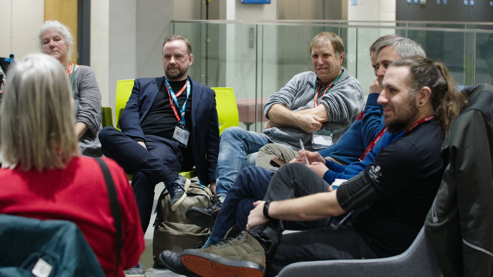Group of professionals engaged in discussion at a film industry conference or event in an indoor setting.