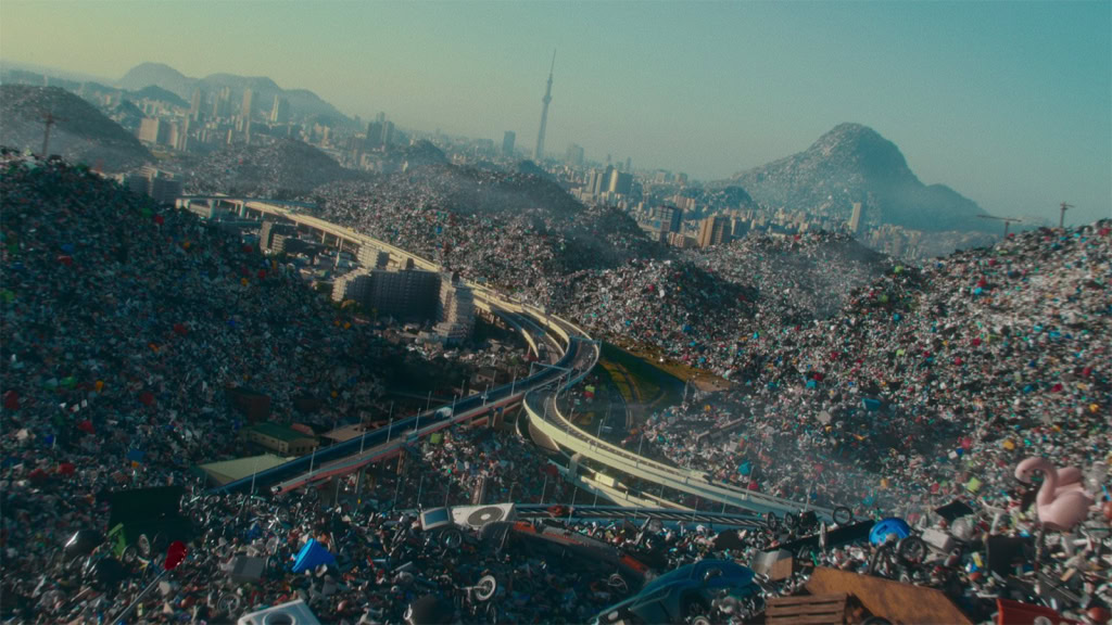 Overflowing landfill mountains with urban skyline and mountain backdrop in Mexico City.