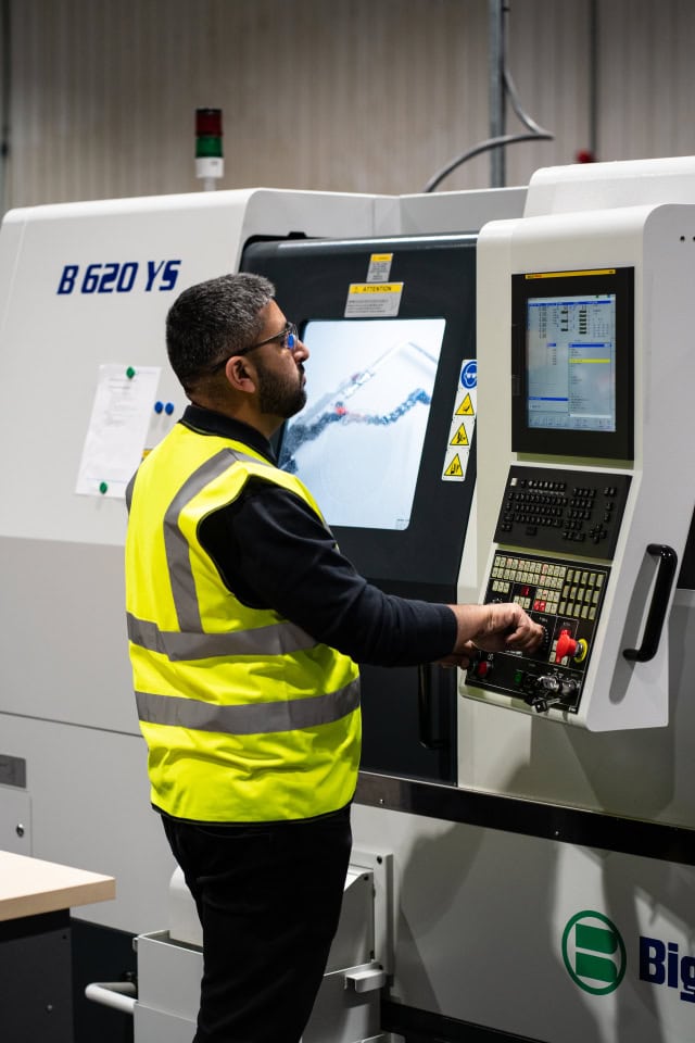 B620YS CNC machine operator working in a manufacturing facility.