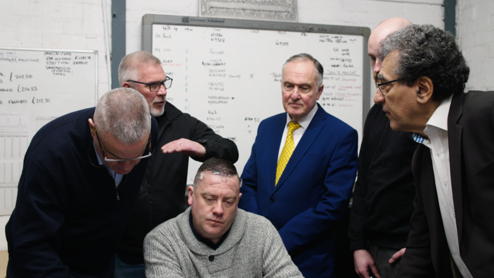Business team discussing energy solutions in a modern office setting.