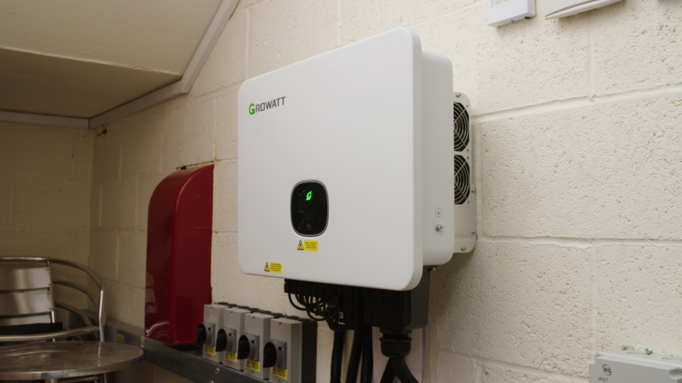 Modern energy management device mounted on wall for smarter energy solutions.