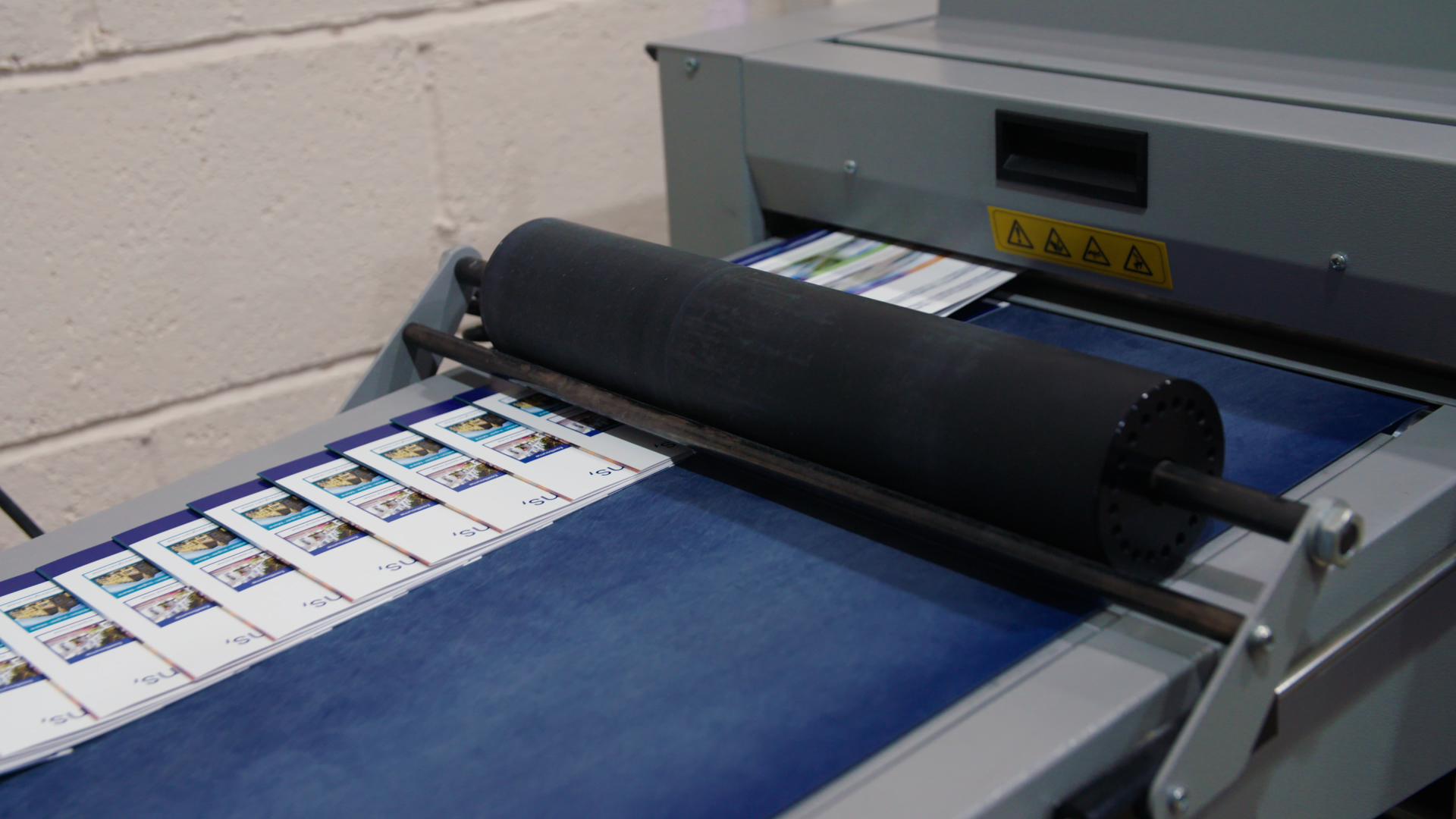 Industrial printer producing energy-efficient marketing materials.