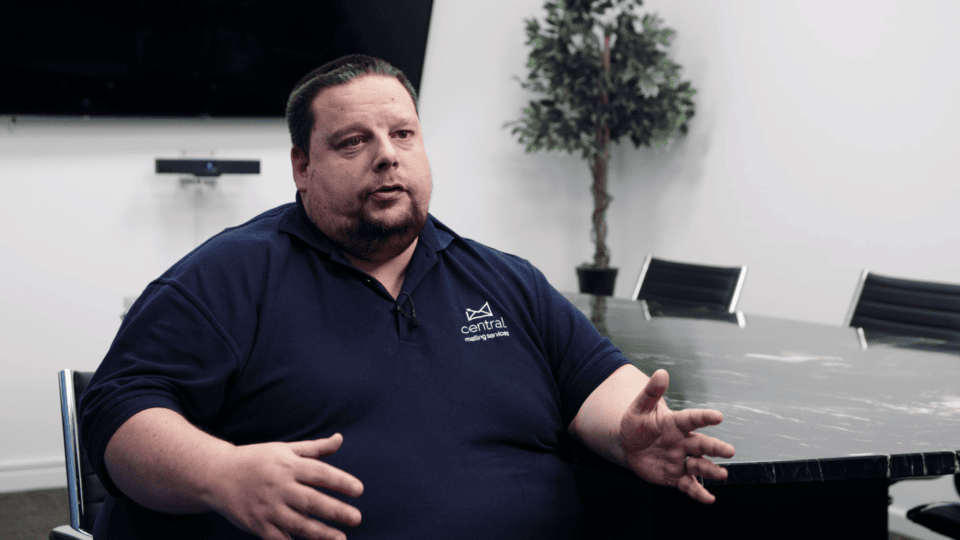 Man discussing sustainability strategies in a corporate meeting room.