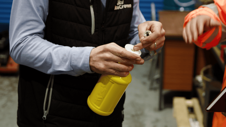 Person applying eco-friendly cleaning product in a workshop setting.