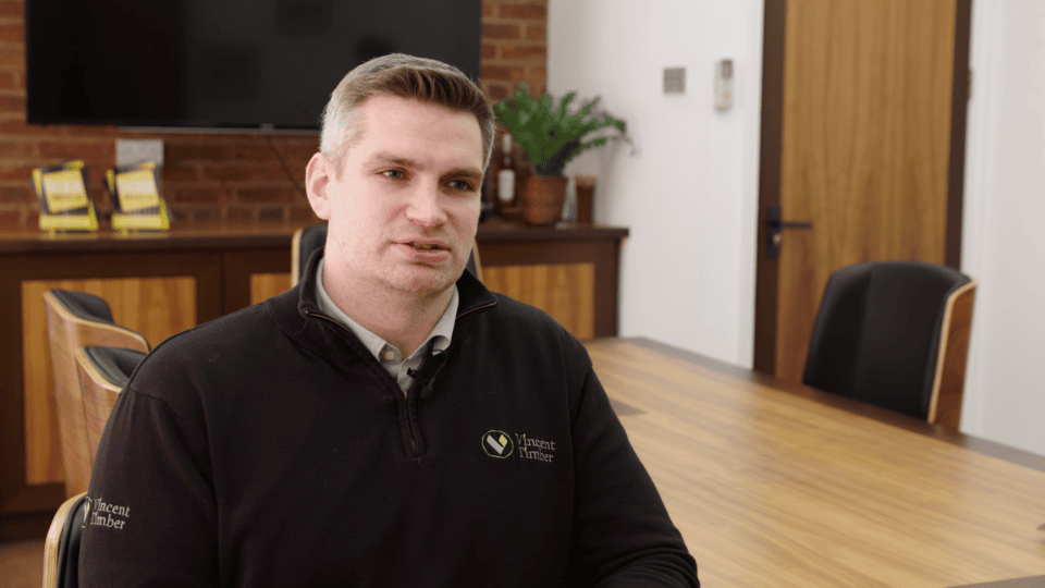 Business professional discussing sustainability strategies in an office.